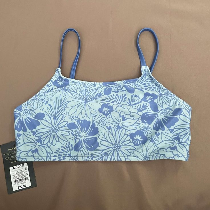 Two Tone Blue Floral Design Top. Full Coverage Crop. New Sports Blue Printed Swimwear, Blue Seamless Sleeveless Tankini, Blue Sleeveless Seamless Tankini, Blue Seamless Summer Tankini, Blue Tankini With Adjustable Straps For Sports, Blue Sports Tankini With Adjustable Straps, Light Blue Seamless Tops For Beach, Casual Blue Tankini With Adjustable Straps, Light Blue Seamless Top For Beach