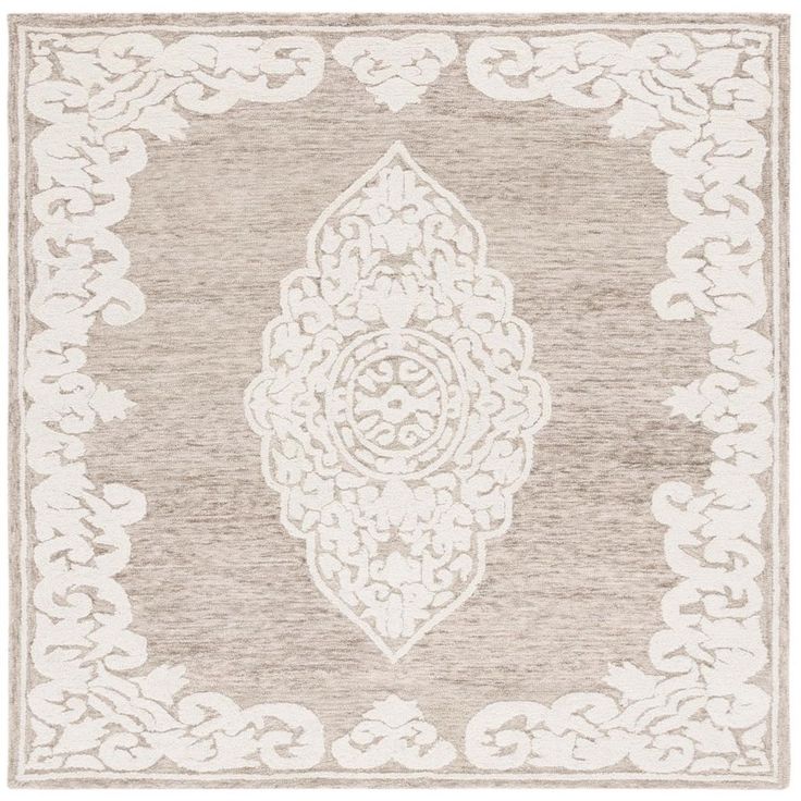 a beige and white rug with an intricate design on the bottom, in front of a white background