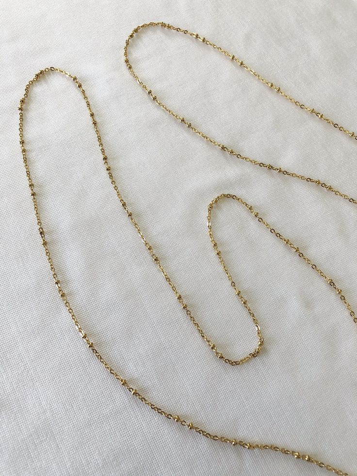 "Add flair to your look with our beautiful chain beaded waist chain! 【𝗗𝗘𝗧𝗔𝗜𝗟𝗦】 ⊳ 18k Gold plated on Stainless steel ⊳ 1.5mm in width ⊳ Length: 32\"/82cms + 4\"/10cm adjustable chain extension ⊳ For custom sizes, please contact us. ⊳ Hypoallergenic - Suitable for sensitive skin ⊳ Anti-tarnish & water-resistant   【𝗦𝗛𝗢𝗣 𝗢𝗨𝗥 𝗕𝗢𝗗𝗬 𝗖𝗛𝗔𝗜𝗡𝗦】- https://etsy.me/3gpMgwv 【𝗙𝗔𝗤𝘀】 For any information regarding delivery, returns & exchanges, size guides, product care and other general information, please visit our shop (link below) and scroll right down to the bottom of the page under the 'Frequently asked questions' section. ↣ 𝗢𝘂𝗿 𝘀𝗵𝗼𝗽: https://etsy.me/3D41JMz If you have any further questions, please don't hesitate to send us a message. ↣ Follow us on Instagram: @surade Elegant Beaded Waist Chain As A Gift, Party Chain Necklace With Adjustable Chain And Round Beads, Dainty Adjustable Waist Chain For Party, Minimalist Gold Body Chain, Gold Lariat Body Chain Gift, Gold Lariat Body Chain As Gift, Gold Delicate Chain Body Chain Gift, Dainty Gold Waist Chain For Party, Elegant Gold Beaded Body Chain