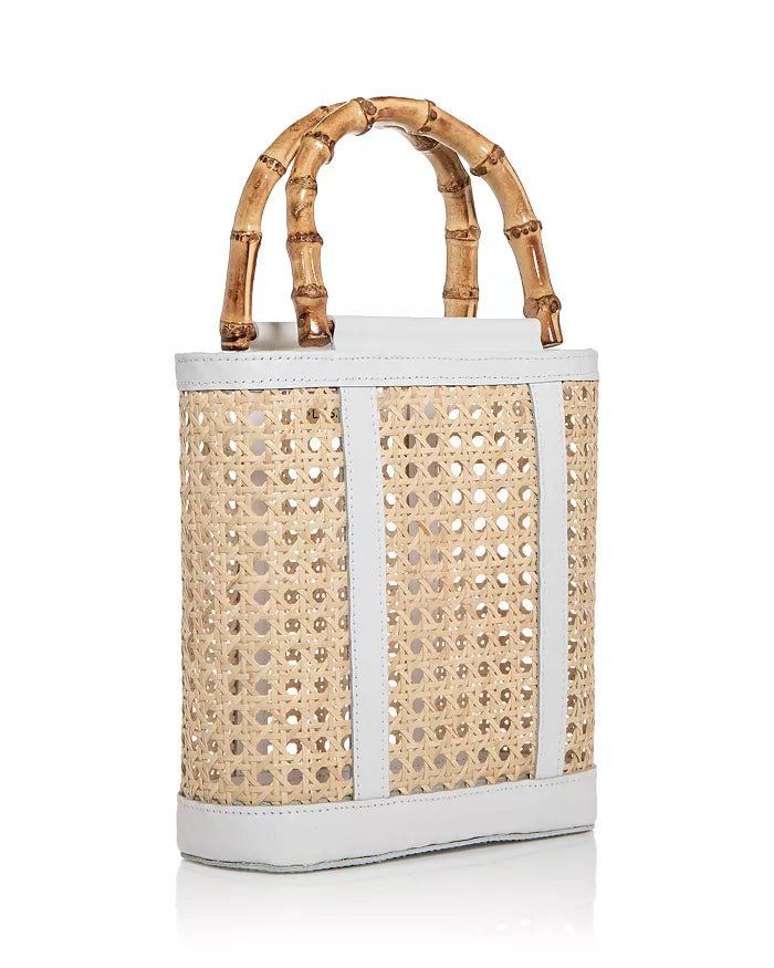 Discover the elegant Emerald Open Weave Rattan Mini Tote by Lusana. This stylish bag features an open top design with faux bamboo wood-tone handles and leather trim accents. Crafted from rattan and leather, this lightweight and versatile bag is perfect for any occasion. Double handles with a 4" drop 9"W x 3"D x 8.5"H Imported Leather Bucket Bag With Bamboo Handle In Natural Color, Natural Leather Bucket Bag With Bamboo Handle, Luxury Straw Bucket Bag With Bamboo Handle, Chic Rectangular Bucket Bag With Bamboo Handle, Modern Straw Bag With Bamboo Handle For Vacation, Leather Bucket Bag With Bamboo Handle For Beach, Leather Bucket Bag With Bamboo Handle For Vacation, Leather Straw Bag With Top Carry Handle For Vacation, White Leather Shoulder Bag For Vacation