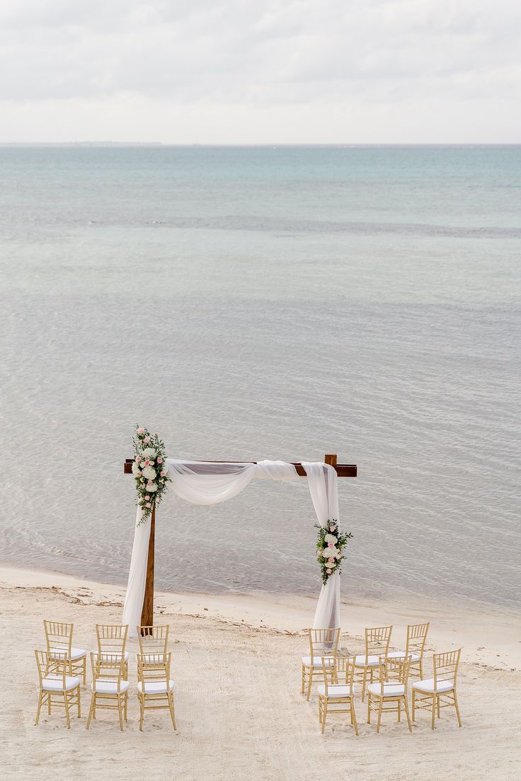 an outdoor wedding set up on the beach