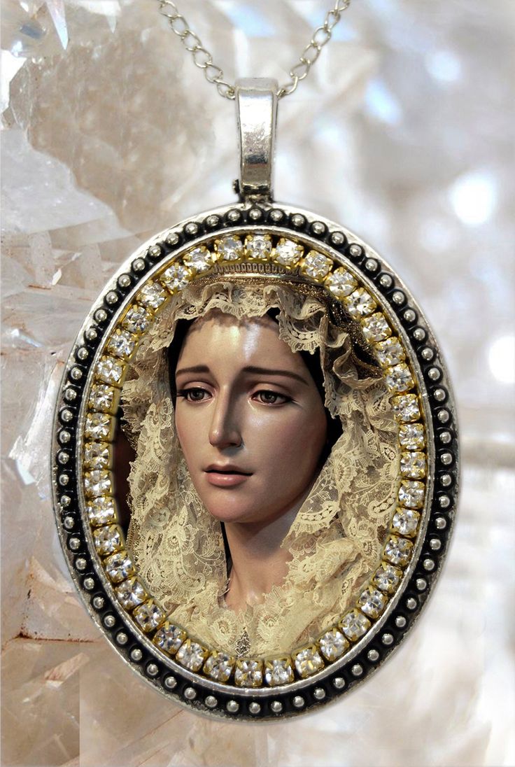 - Necklace of Saint Maria De La Estrella Vélez Malaga . I created this unique and meaningful necklace designs in honor of Saint Maria De La Estrella. Express your faith and devotion with this handmade piece it's a very powerful piece and a true gift for yourself or someone special. . Created With: Beautiful 57x37mm pendant with an image of Our Saint Maria De La Estrella with white rhinestones. Materials: Rhinestones & Metal . Please note this necklace its handmade by hands that love to creat Oval Large Pendant Necklaces For Wedding, Elegant Silver Jewelry For Commemoration, Virgin Mary Pendant Jewelry Gift, Virgin Mary Pendant Jewelry As A Gift, Spiritual Medallion Necklace For Wedding, Oval Virgin Mary Jewelry Gift, Spiritual Wedding Jewelry With Large Pendant, Silver Necklace With Large Pendant For Commemoration, Elegant Round Pendant Necklace For Commemoration