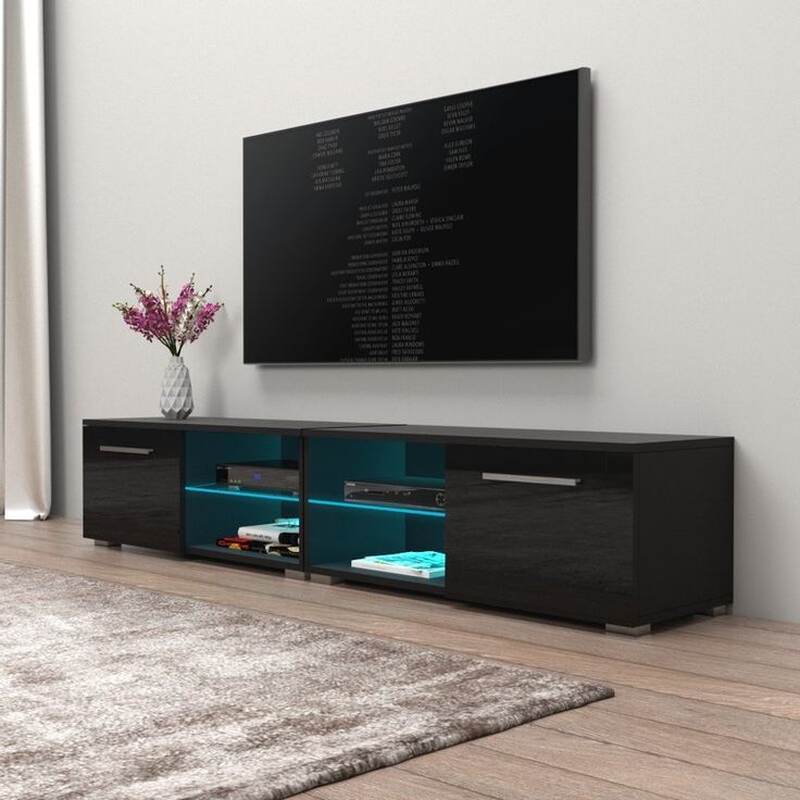 an entertainment center with a large television mounted on the wall