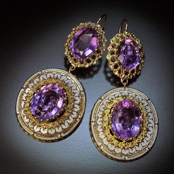 Circa 1860s-1870sFrom the Victorian era, these Day to Night earrings are crafted in polished and textured three color gold (yellow, green, and rose) . The earrings are set with four oval amethysts of a light to medium purple color. The detachable pendants are embellished with white opaque enamel.Weight 10 grams each.Total length with ear wire – 62 mm (2 1/2 in.)Width – 30 mm (1 3/16 in.) Luxury Ceremonial Pierced Earrings, Victorian Oval Pierced Earrings, Victorian Filigree Oval Earrings, Victorian Oval Filigree Earrings, Antique Earrings With 17 Jewels For Ceremonial Occasions, Luxury Ceremonial Earrings With Intricate Design, Victorian Style Hallmarked Earrings For Formal Occasions, Formal Victorian Hallmarked Earrings, Victorian Yellow Gold Earrings With Intricate Design