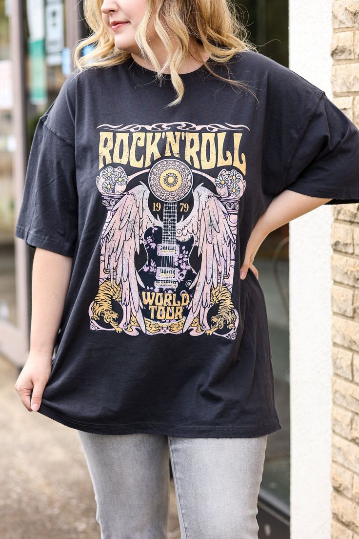 Our "Rock and Roll Tee" is a black t-shirt that that says "rock and roll" in yellow on the front. It has a guitar design on it. These are an oversized fit. Black Cotton Rock And Roll T-shirt, Trendy Band Logo T-shirt For Concerts, Relaxed Fit Rock And Roll T-shirt For Streetwear, Rock And Roll Graphic T-shirt For Music Festival, Rock And Roll Band Logo T-shirt For Streetwear, Rock Band Logo T-shirt Relaxed Fit, Rock Band Logo T-shirt In Relaxed Fit, Rock Style Band Logo T-shirt With Relaxed Fit, Rock Style Band Logo T-shirt In Relaxed Fit