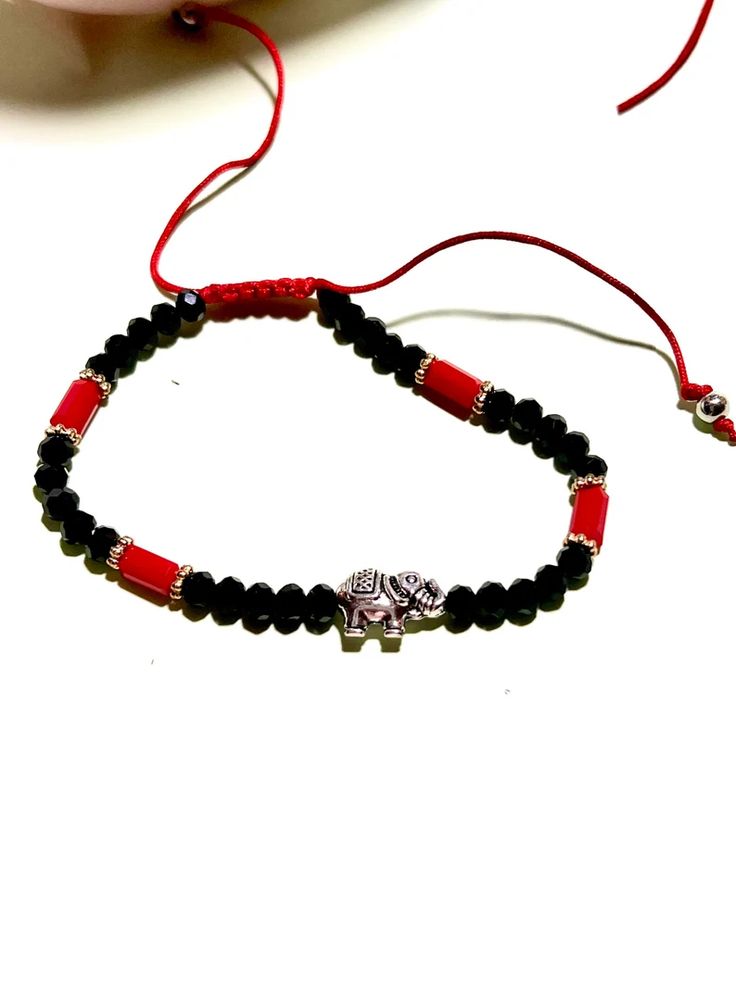 Good Luck Elephant Charm Red & Black Bracelet - Etsy Serbia Traditional Adjustable Black Bracelets, Traditional Black Adjustable Beaded Bracelets, Traditional Black Adjustable Bracelets, Traditional Black Adjustable Bracelet, Handmade Symbolic Black Bracelets, Red Spiritual Bracelet With Black Beads, Handmade Symbolic Black Beaded Bracelets, Traditional Black Friendship Bracelets As Gift, Traditional Black Friendship Bracelet As Gift