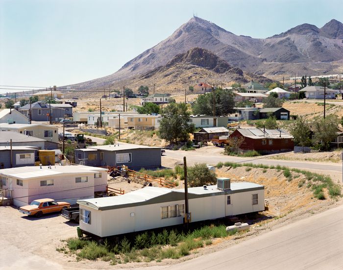 an aerial view of a small town with mountains in the background