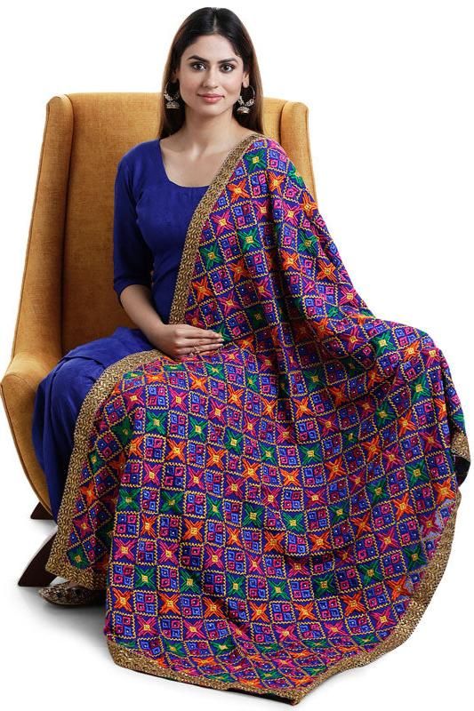 Enhance your traditional look with our Designer Phulkari Dupatta. This beautiful dupatta chunni is crafted in Chinon silk fabric with all-over heavy Phulkari embroidery and makes the perfect accessory for special occasions such as weddings, receptions and sangeet.    Chinon Silk  All over multicolor phulkari embroidery, sequins, gold border lace  Size: 2.25 meter  Dry clean  Dispatched in 1-3 business days Anarkali Mulmul Dupatta With Zari Work, Bollywood Style Traditional Drape Mulmul Wear, Bollywood Style Mulmul Traditional Wear, Blue Mulmul Dupatta With Cutdana, Designer Multicolor Anarkali Set With Motifs, Multicolor Motif Anarkali Set For Designer Wear, Multicolor Anarkali Set With Motifs For Designer Wear, Multicolor Mulmul Kurta With Dupatta, Multicolor Mulmul Anarkali Traditional Wear