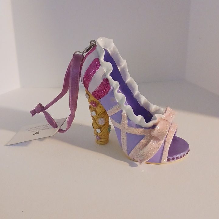 a pair of purple and white shoes on top of a table