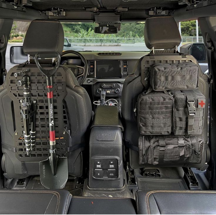 the interior of a vehicle with several items in it's cargo compartment, including an electronic device and other gadgets