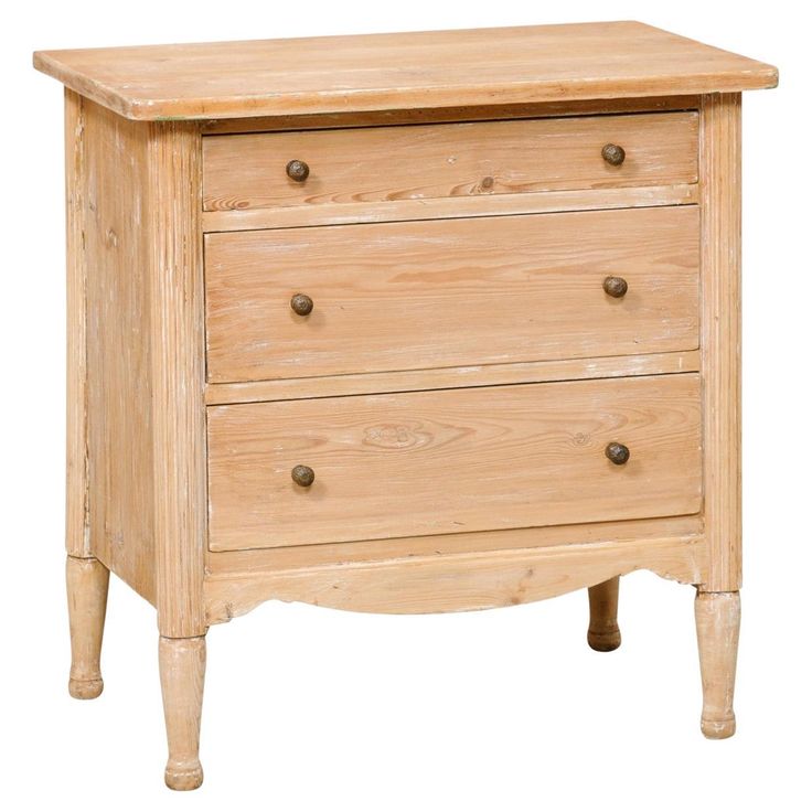 a wooden dresser with three drawers on one side and two knobs on the other