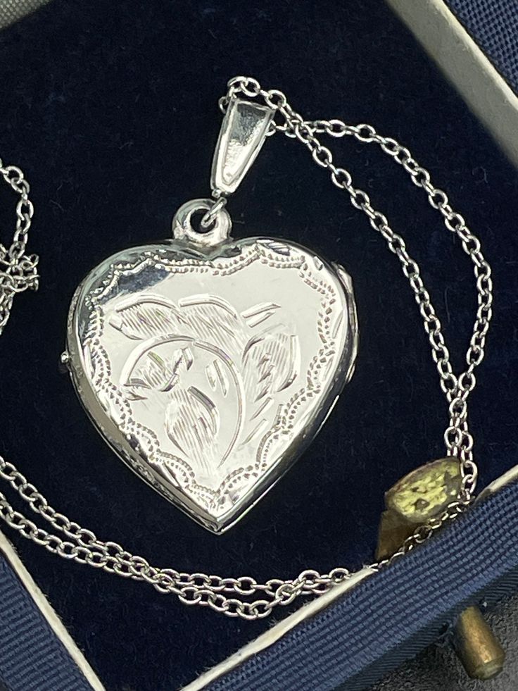 Vintage  silver locket for women. Double sided silver locket with hand engraved back and front. Double photo locket.   Silver heart locket. Silver pendant . Silver necklace for women.        Condition: necklace in perfect vintage condition. Materials: Silver. Rhodium plated silver chain.  Measure: chain 16"/ 41 cm,   Locket  0.7" x 0.7"/  1.8 x 1.8 cm. Package: gift wrap available, please specify when ordering. Delivery: your order will be send by Royal Mail with tracking and signed in 1-2 worki Double Photo, Silver Locket, Gift For Her Birthday, Photo Locket, Silver Lockets, Heart Locket, Locket Necklace, Double Face, Hand Engraving