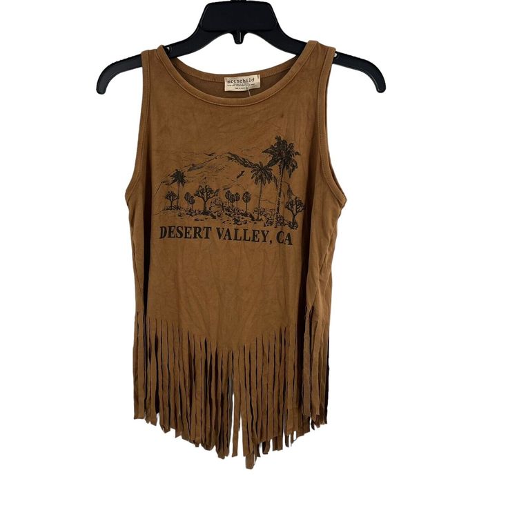 Wide Neckline Sleeveless Front Graphic Fringe Hem Extra Soft Faux Suede Fabric Boho Aesthetic New With Tags Armpit To Armpit 17" Length 17" Plus 7" Fringe Brown Sleeveless Crop Top For Summer, Sleeveless Brown Crop Top For Summer, Brown Vest Crop Top For Summer, Trendy Brown Sleeveless Tank Top, Trendy Cotton Festival Tank Top, Trendy Cotton Tank Top For Festivals, Summer Brown Cotton Tank Top, Brown Cotton Summer Tank Top, Sleeveless Graphic Print Crop Top For Festival