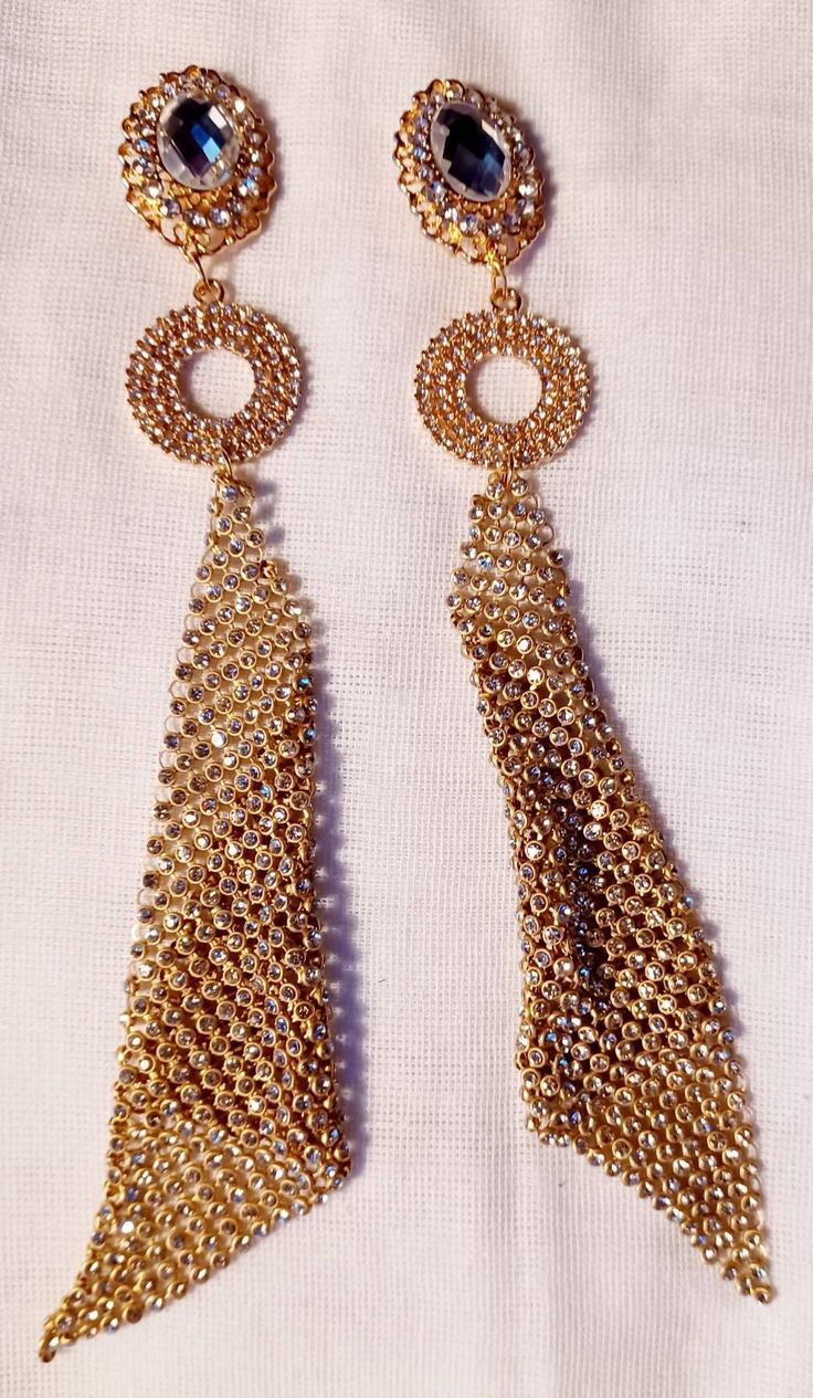 Large style These hang 6 inches Handmade originals Gold and rhinestone metal clip on Very unique gold metal mesh design Very blingy and cute These are very lightweight on the ear Easy to wear Statement style They are one of a kind These Earrings are a classic and timeless addition to any wardrobe Glamorous Gold Clip-on Earrings For Evening, Metal Clip-on Earrings For Party, Glamorous Metal Clip-on Earrings For Party, Glamorous Party Clip-on Metal Earrings, Gold-tone Metal Clip-on Earrings For Party, Gold-tone Clip-on Earrings For Parties, Gold Crystal Jewelry With Rhinestone Fringe, Gold Rhinestone Metal Earrings, Gold Metal Earrings With Rhinestones