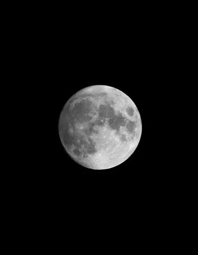 the full moon is seen in black and white, as it appears to be dark