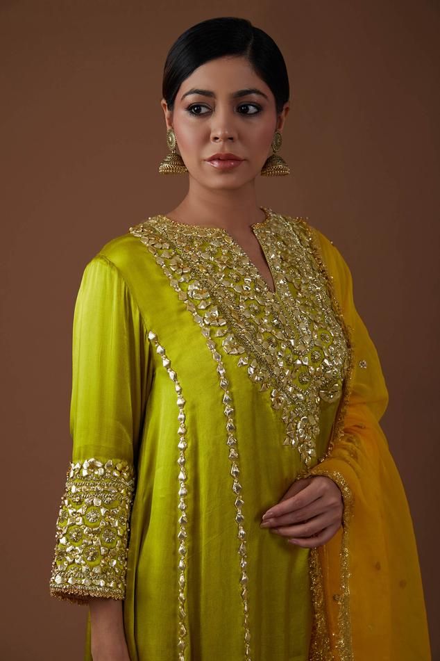 Mist green kurta with gota, sparkling sequin, lustrous pearl, nakshi embellishment on yoke. Paired with pleated salwar and sunkissed dupatta.
Components: 3
Pattern: Embellishment
Type Of Work: Gota, sequin, pearl, nakshi
Neckline: Notched
Sleeve Type: Long sleeves
Fabric: Kurta and Salwar: Mashru Silk, Dupatta: Organza
Color: Green
Other Details: 
Fringe border
Contrast dupatta
Embroidery on salwar hem
Model height: 5ft 7inches, wearing size M
Occasion: Sangeet - Aza Fashions Hand Embellished Straight Kurta Salwar Kameez For Designer Wear, Designer Hand Embellished Straight Kurta, Festive Unstitched Hand Embellished Salwar Kameez, Semi-stitched Hand Embellished Kurta For Diwali, Festive Semi-stitched Hand Embellished Salwar Kameez, Bollywood Style Semi-stitched Hand Embellished Kurta, Festive Anarkali Style Hand Embellished Palazzo Set, Bollywood Style Hand Embellished Straight Salwar Kameez, Hand Embellished Chinon Kurta For Designer Events