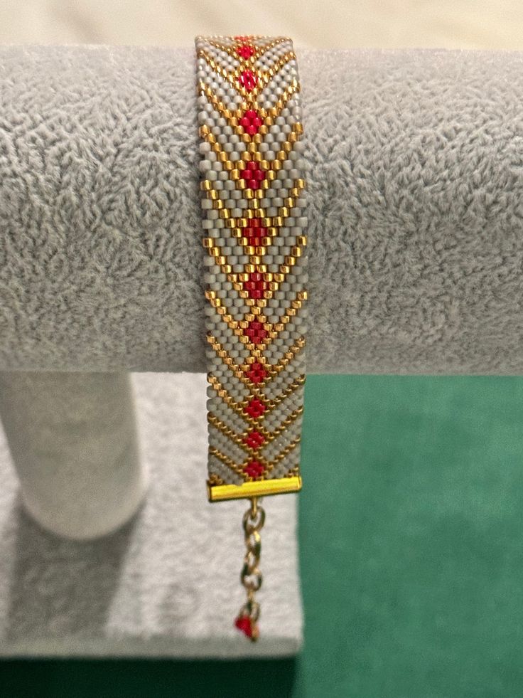 a close up of a bracelet on a stand