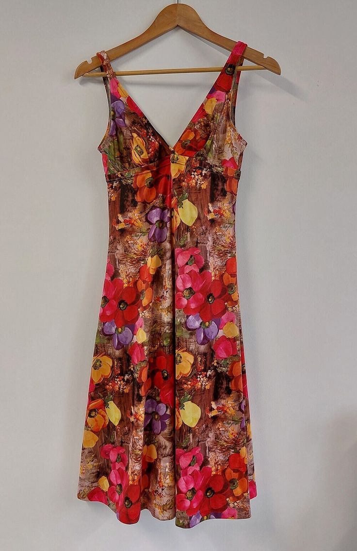 "Fabulous floral print mid-length sleeveless summer dress, circa late 1960s/early 1970s. Fitted style to bust with strappy V-neckline, and full skirt.  The perfect dress for a summer celebration or evening out!  Material: Polyester Condition: Excellent vintage condition - no damage or obvious signs of wear Recommended care: Machine wash Sizing: Label states UK Size 14 - would recommend current UK Size 10/12. Please see exact measurements below. Measurements (item laid flat): - Length (straps to hem) 106cms/41.75\" - Bust (width, doubled) 70cms/27.5\" - Waist (width, doubled) 80cms/31.5\" All items are clean and ready to wear. Want any further details, images or measurements? Feel free to get in touch if you'd like any further information about this item. RETURNS If an item doesn't quite fi Vintage V-neck Floral Dress For Spring, Summer Party Dress With Vintage Print, Vintage Summer Floral Dress For Party, Retro Fitted Floral Summer Dress, Vintage Floral Dress For Summer Party, Fitted Retro Floral Dress For Summer, Vintage Sleeveless Dress With Vibrant Print, 1970s Multicolor Summer Dresses, Multicolor 1970s Summer Dresses