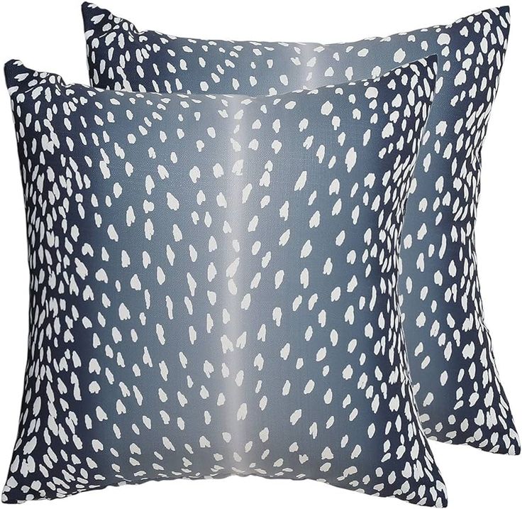 two blue pillows with white spots on the front and back, one in black and white