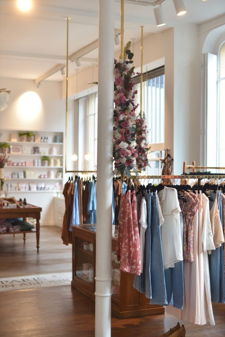 clothes are hanging on racks in a store