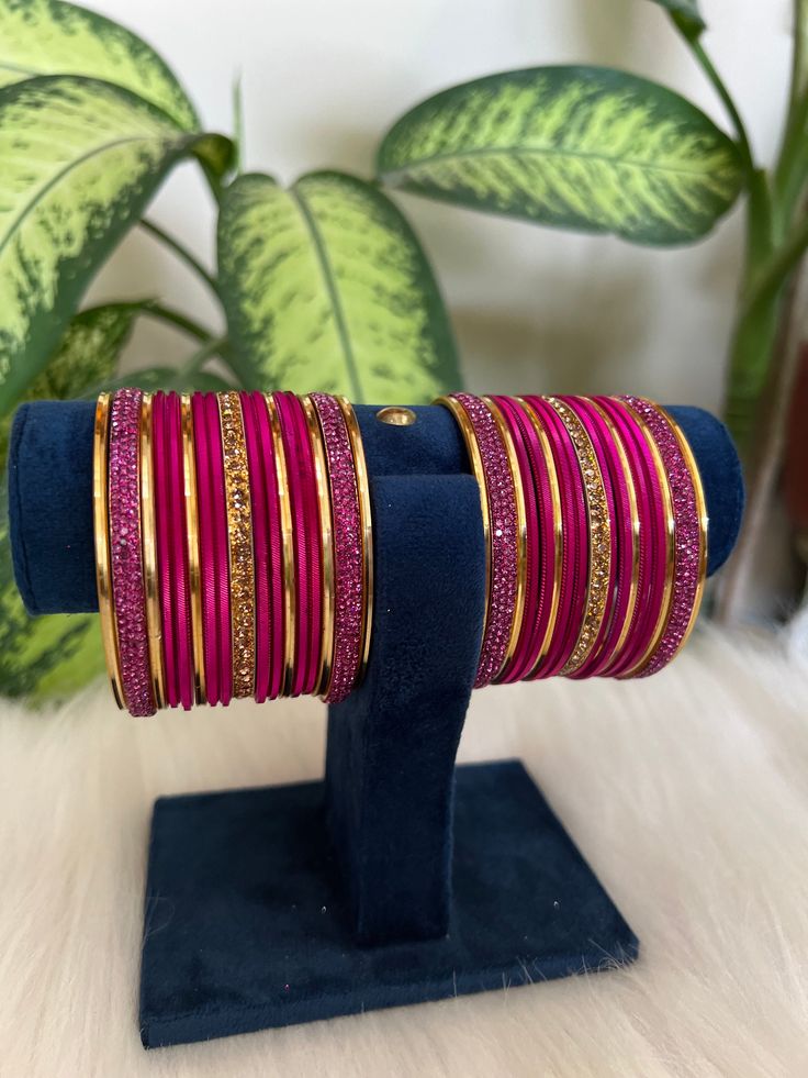 The perfect accessory for your special occasions, these  Hot pink and golden Color Bangles feature Pearl and Stone detailing. Crafted with copper, these bangles are sure to add a touch of elegance and glamour to your look. Features: * Copper material *  Stone detailing *   Hot pink and golden Color * Size: 2.6,2.8,2.10 Traditional Pink Bracelets For Festive Season, Traditional Pink Bracelets For Festive Occasions, Traditional Pink Bracelet For Festive Occasions, Traditional Pink Bracelet For Festive Season, Handmade Pink Bangle For Festive Occasions, Pink Handmade Traditional Bangle, Traditional Pink Bangle For Festive Occasions, Traditional Pink Bangle For Festive Season, Traditional Pink Festive Bangle