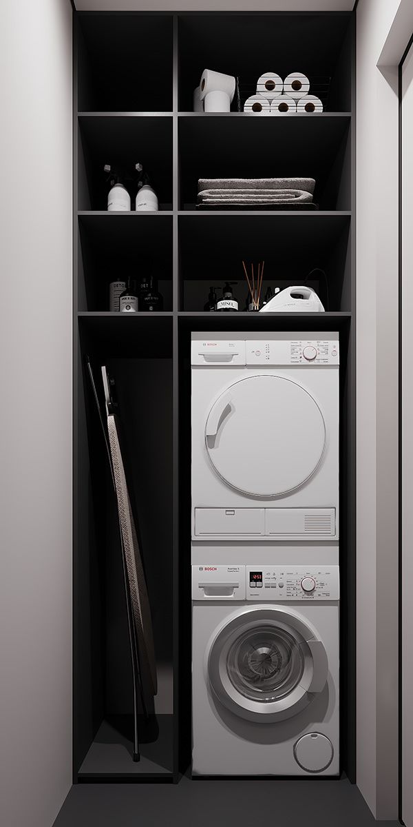 a white washer sitting inside of a bathroom next to a closet filled with toilet paper