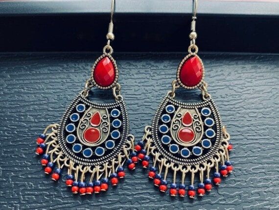 Boho Red Dangle Earrings, Indian Beaded Tassel Earrings, Antique Teardrop Earrings, Large Statement Earrings, Colorful Enameled Earrings, Bohemian Jewelry for Woman ❤️Boho your way! Thanks for stopping by! We have many unique items here, please take a moment to visit! -Your order will be shipped out within 2 business days after the order has been received. -These earrings are light weight and easy to wear, perfect for your daily look. -They're designed with different geometric shapes like circle, triangle, diamond, teardrop etc, they can show your personality in different styles. -These earrings are also perfect gifts for friends and families, the exquisite accessory for women.  -They fit all of your fashion needs, for any formal and informal occasions, such as party, vacation, prom, weddi Red Metal Earrings For Festivals, Red Teardrop Jewelry For Festival, Red Drop Earrings With Latkans, Red Dangle Chandelier Earrings For Festivals, Red Chandelier Earrings For Festivals, Traditional Tassel Earrings With Dangling Beads As Gift, Red Dangle Beaded Earrings, Teardrop Tassel Jewelry, Dangling Beads Danglers As A Gift