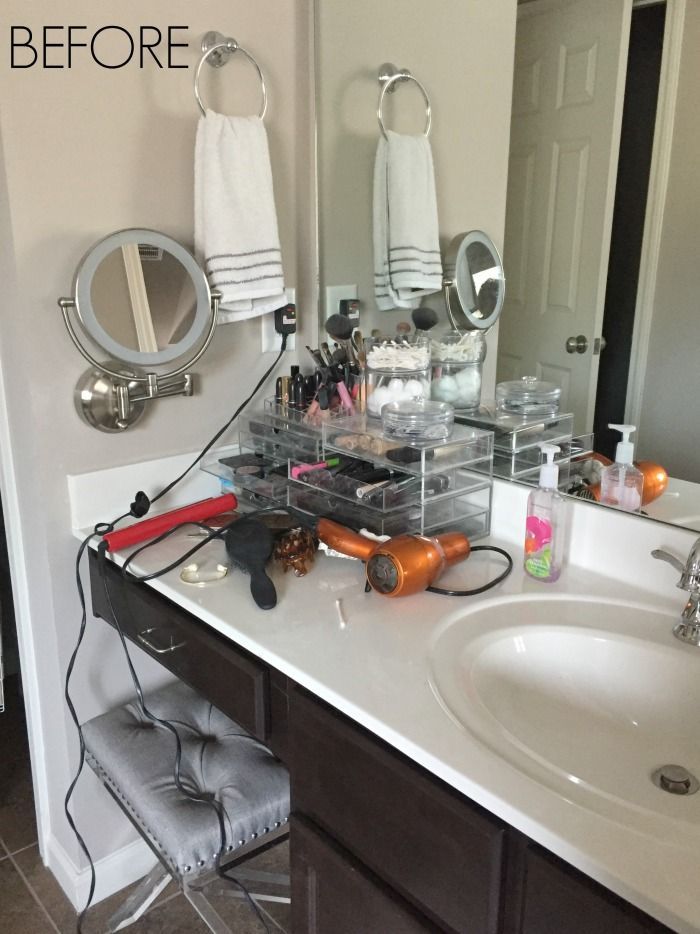 a bathroom with a sink, mirror and hair dryer on it's counter