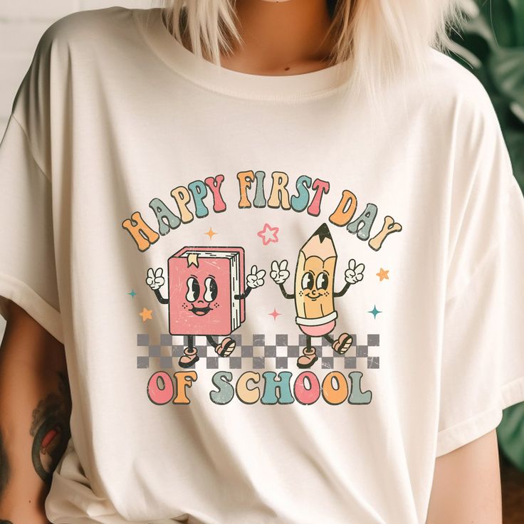 a woman with blonde hair wearing a happy first day of school t - shirt and shorts