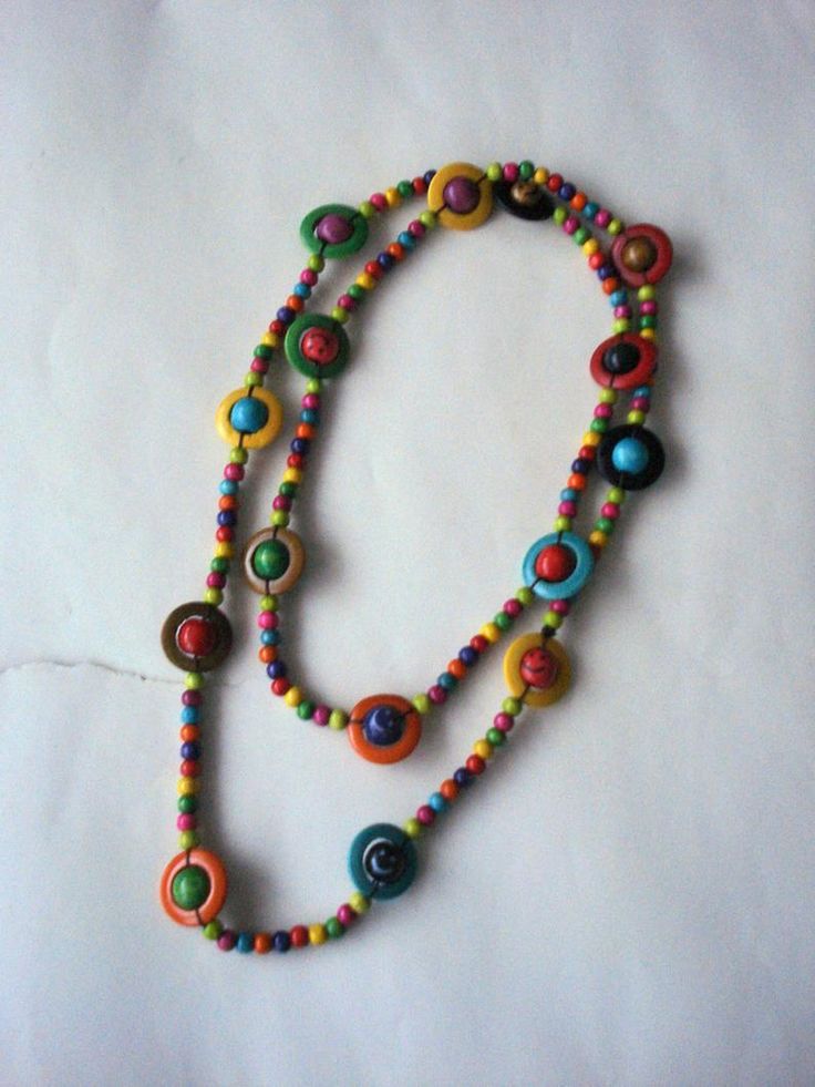 a multicolored beaded necklace on a white surface