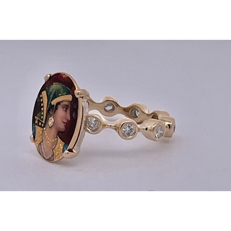 This is part of Chairish’s Fine Jewelry assortment.  Enamel Faced Portrait of Athena Ring 14K  This ring has a beautiful face of Athena a Roman goddess.  This started life as a Stick pin but I couldn't help myself I had to turn this into a ring.  The face is beautiful with a tiny Diamond on her ear.  The band is set with ten 0.10 point Diamonds circling the band. Colors are beautiful it weighs in at 6.09 grams and is a size 5 3/4. This ring is perfect for those with smaller fingers or it can be Collectible 14k Gold Multi-stone Rings, Collectible Multi-stone 14k Gold Rings, Fine Jewelry Collectible Enamel Ring, Oval Enamel Gemstone Ring In 14k Gold, Collectible Enamel Fine Jewelry Ring, Unique Oval Yellow Gold Diamond Ring, Oval 14k Gold Enamel Ring Fine Jewelry, Oval Diamond Ring For Collectible, Unique Multi-stone Oval Diamond Ring