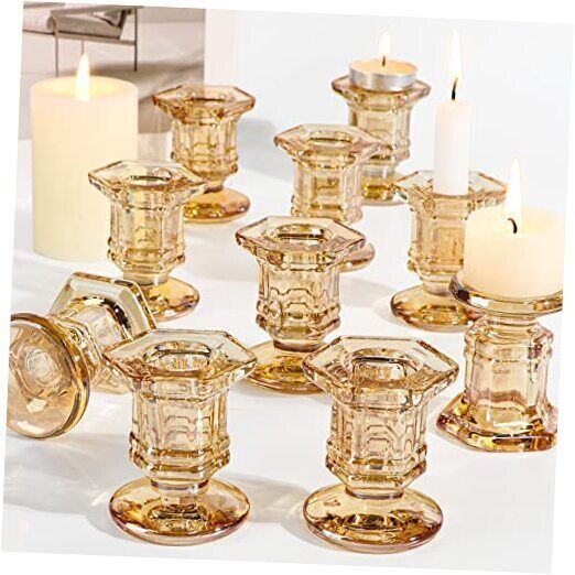 there are many glass candles on the table