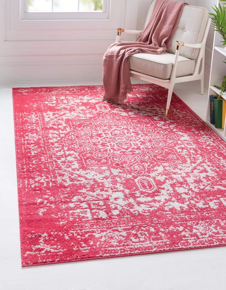 a red rug with white flowers on it in front of a window and a chair