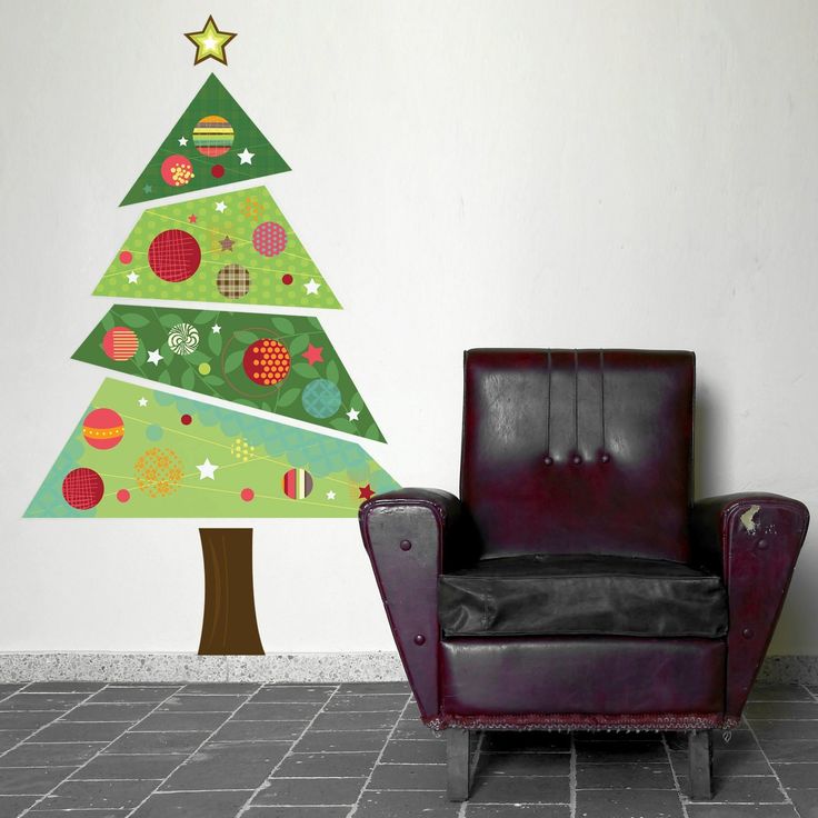 a chair sitting in front of a wall with a christmas tree on it and the word spin above it