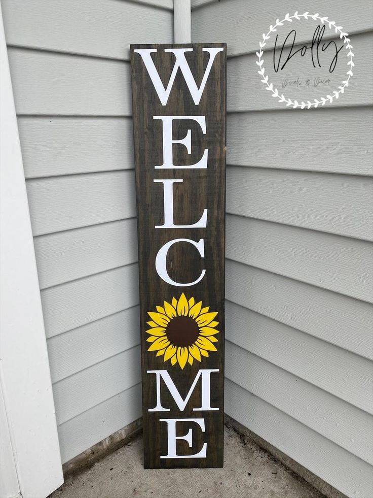 a welcome sign with a sunflower painted on it