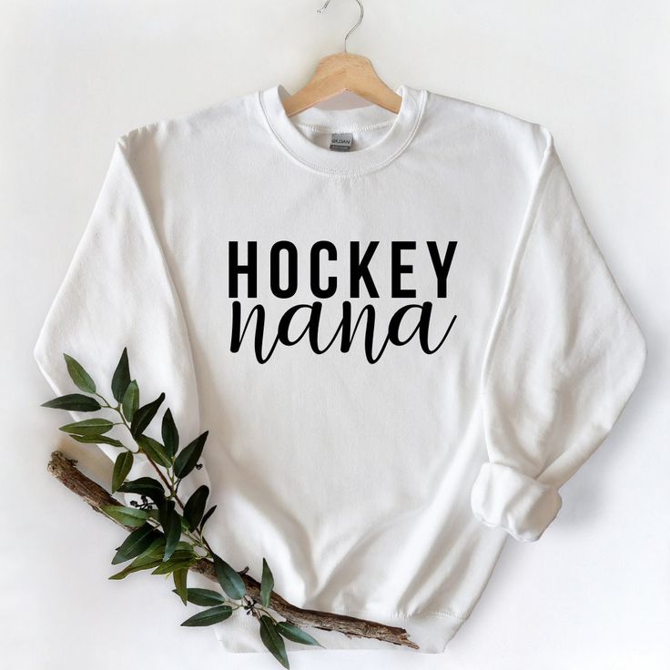 "ABOUT THE CREWNECK SWEATERS: This heavy blend unisex sweatshirt is made from 60/40 polyester/cotton. Features a unisex, comfy-fit, which is perfect for lounging, heading to the gym or running errands like heading to hockey practice or groceries! Sizes: S, M, L, XL, 2XL (fit a tad large on a woman, as they are UNISEX) We ask that you please check the measurements prior to ordering. Hockey Nana Sweater, Hockey Nana Sweatshirt, Grandma Christmas, Nana Gift, Crewneck Sweatshirt, Canadian Made, Gift for Her, Gift for Nana HOW TO ORDER: 1. Select the size and colour of the shirt you would like. 2. Add the quantity of each shirt you would like and then click \"Add to Cart\" 3. Please leave us any additional information in the notes to seller section 4. Submit Order. This listing is for ONE sweat Grandma Sweater, Hockey Sweatshirts, Grandmas Christmas, Nana Shirts, Christmas Gifts For Grandma, Nana Gifts, Gildan Sweatshirts, Comfy Fits, Running Errands