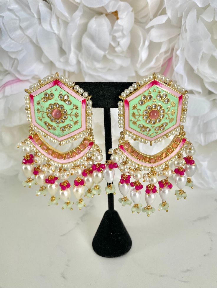 "Mint Green Meenakari Earrings and Tikka Set If you're looking for a jewelry set to wear to an upcoming Indian event, look no further - with handpainted details and pearl accents, this traditional mint green meenakari earring and tikka set has our heart!  These earrings are perfect for Indian weddings and festivities (I would wear these to a sangeet party). These also make for a pretty & memorable gift for special occasions! Details: 1 pair of hand-painted meenakari earrings 1 matching tikka  Shop more of our Indian Earrings here: https://www.etsy.com/shop/jazzyandco?section_id=23690892 What is Meenakari? Meenakari is a Persian art of colouring the surface of metals by fusing brilliant colours. The art was brought to India by Persian enamellists around the early 17th century. Mina is the f Cheap Meenakari Jewelry For Festive Occasions, Luxury Meenakari Party Sets, Affordable Meenakari Jewelry For Festive Season, Luxury Designer Meenakari Jewelry, Cheap Traditional Meenakari Earrings, Festive Meenakari Jewelry, Fusion Chandbali Earrings With Meenakari, Fusion Chandbali Meenakari Earrings, Fusion Meenakari Chandbali Earrings