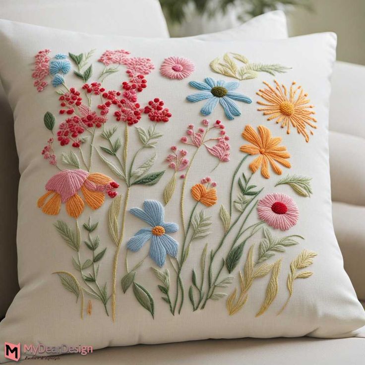 an embroidered pillow with colorful flowers on it