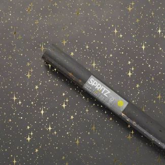 a pen sitting on top of a table covered in stars