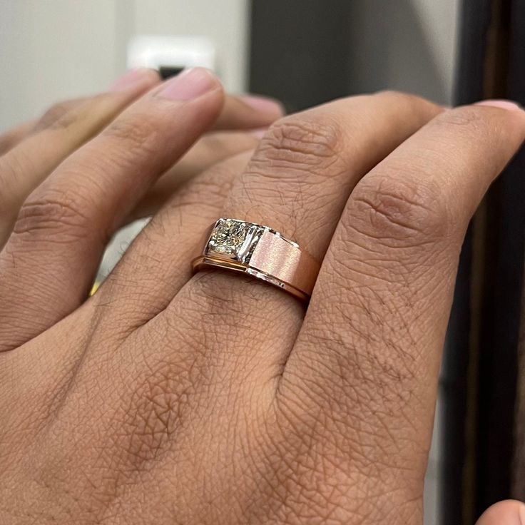 a person's hand with a ring on it