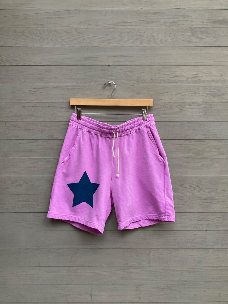 broken in and extremely soft lilac long shorts feel like a dream to wear they are so comfy. slightly small unisex fit but check the sizing chart below for best fit- waistband is very stretchy. all cotton, two front pockets, drawstring and then i hand print a teal blue star on the front.  sizing: slightly small unisex fit S: 28-30" waist + length 17" M: 30-32" waist, length 17" L: 34" waist, length XL: 36-38" waist, length  im happy to print another design on these shorts but i do not accept exch Cheap Purple Shorts With Pockets, Lavender Relaxed Fit Bottoms For Summer, Lavender Relaxed Fit Pants For Summer, Comfortable Cotton Pink Bottoms, Comfortable Pink Cotton Bottoms, Pink Bottoms With Built-in Shorts And Relaxed Fit, Pink Cotton Short Leg Bottoms, Pink Cotton Athletic Shorts With Built-in Liner, Pink Cotton Athletic Shorts With Elastic Waistband