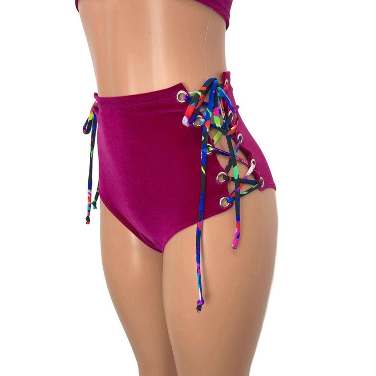 Our classic high waist hot pants with scrunch ruching detail in back to offer a "cheekier" look AND Lace-up sides! These hot pants are made of stretchy fuchsia velvet with splatter print ties and sit high on your natural waist. The lace-up sides make these more adjustable to fit you even better. Wear as a bikini bathing suit bottom, panties, rave shorts, etc. They have a built in liner and are made to be flattering to your figure. Trendy High Waist Bottoms For Pool, High Waist Beachwear Swimwear With Drawstring, Pink Stretch Swimwear With High-cut Leg, Pink Stretch High-cut Leg Swimwear, Pink High-cut Leg Stretch Swimwear, Trendy Stretch High-waisted Swim Shorts, Pink High-waist Bottoms For Poolside, Pink High-cut Leg Bottoms For Summer, Beach Bottoms With Ruched Sides And Tie-side Shape