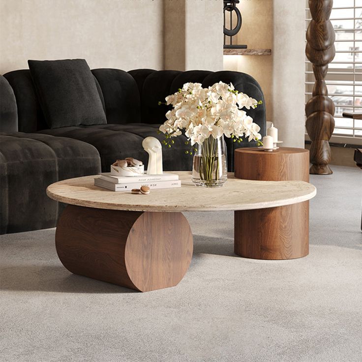 a living room with a couch, coffee table and flowers in a vase on it