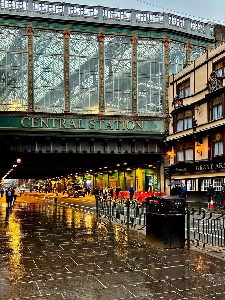 people are walking under an overpass on a rainy day