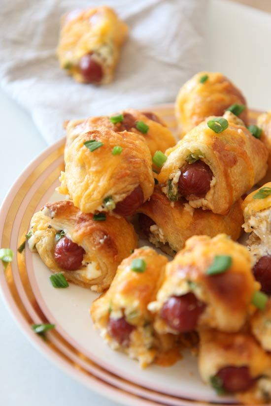 a plate full of sausage and cheese rolls