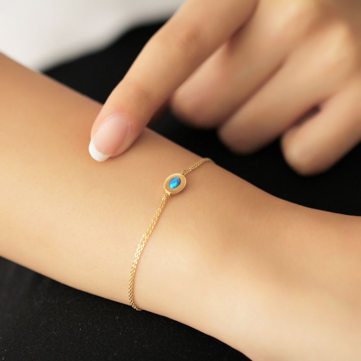 "14k Yellow Gold Oval Blue Opal Stone Bracelet, Bracelet for Women, Minimalist Gold Bracelet, Yellow Gold Wristband, Gift Form Mama Our product is 1.55 gr in weight and 17 cm in length. Your products will be shipped with free shipping UPS express within 1-3 business days. All of our products has the stamp \"585\" on them. (which states that this is real gold) Bracelet Size; 6 Inch: 15.20cm 6.5 Inch: 16.50cm 7 Inch: 17.80cm 7.5 Inch: 19.05cm 8 Inch: 20.30cm There may be +/- 0.15 change in gram in Dainty Oval Chain Bracelet, Minimalist Oval Jubilee Bracelet, Dainty Oval Chain Bracelet Gift, Minimalist Oval Chain Bracelet Gift, Dainty Oval Bracelet For Everyday, Dainty Oval Bracelets As Gift, Dainty Oval Adjustable Bracelets, Adjustable Oval Dainty Bracelets, Dainty Oval Bracelets For Gifts