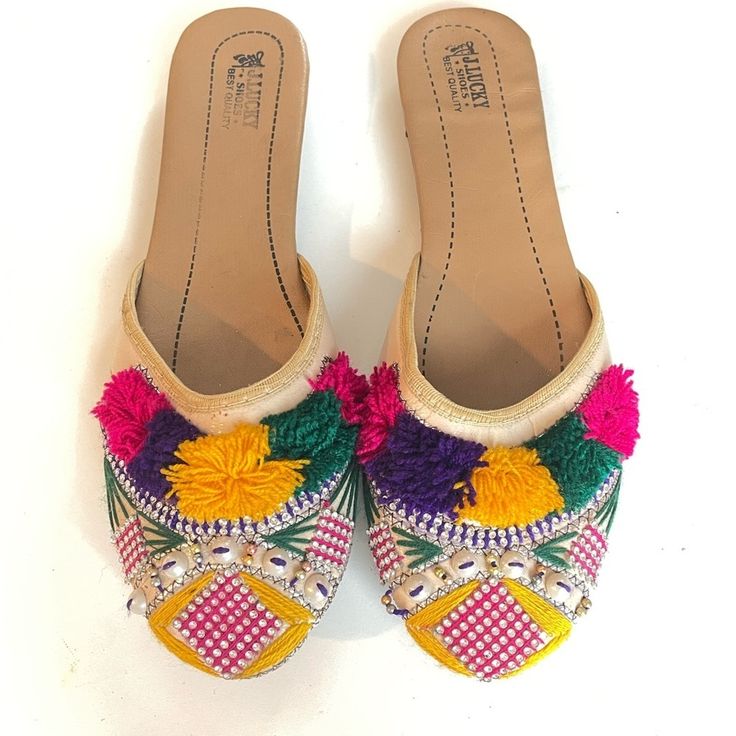 Traditional Stunning Ethnic Indian Pakistani Khussa Flats, Detailed Thread And Faux Peark Work On Beige Shoes. Artistic Multicolor Tassel Details And Rhinestones Work Create A Designer Custom Statement, That No One Ekse Will Be Wearing, But You!! Best For Wedding Or Festivals. These Are Handmade Khussa, Minor Unfinishing Is Normal. Manufacturers Name Got Smudged Due To Storage. Please Check Out Our Other Indo-Pakistani Varieties. Khussa Is Us Size - 8 Color- Beige Base With Multicolored Tassel, Bohemian Multicolor Flat Sandals, Multicolor Bohemian Flats With Round Toe, Festive Summer Slip-on Flats, Summer Festive Slip-on Flats, Bohemian Multicolor Embroidered Sandals, Bohemian Embroidered Closed Toe Flats, Multicolor Slip-on Flats For Festival, Multicolor Slip-on Summer Flats, Multicolor Slip-on Flats For Summer