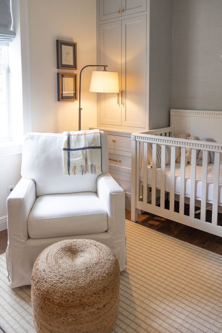 a baby's room with a crib, chair and bed