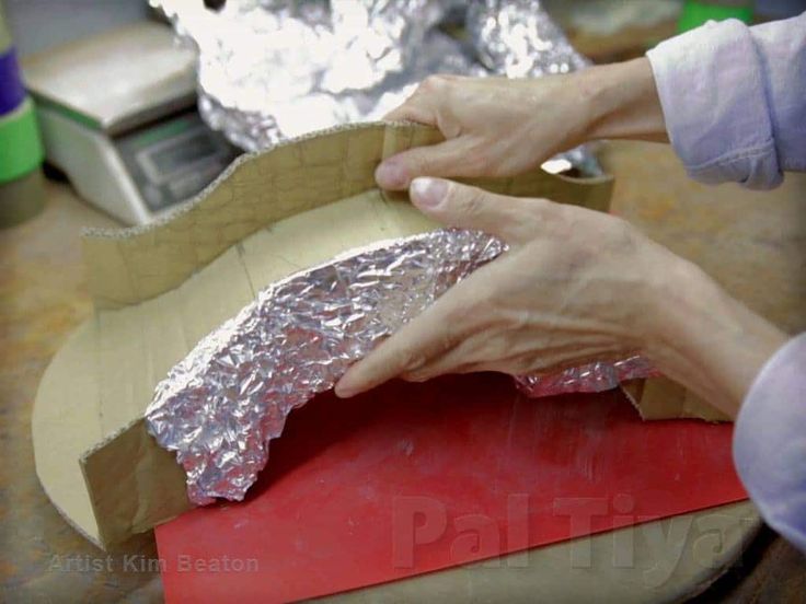 a person is making something out of aluminum foil