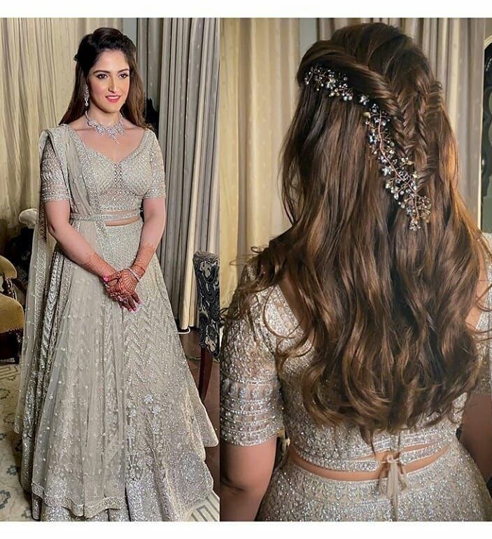 a woman in a wedding dress standing next to a mirror